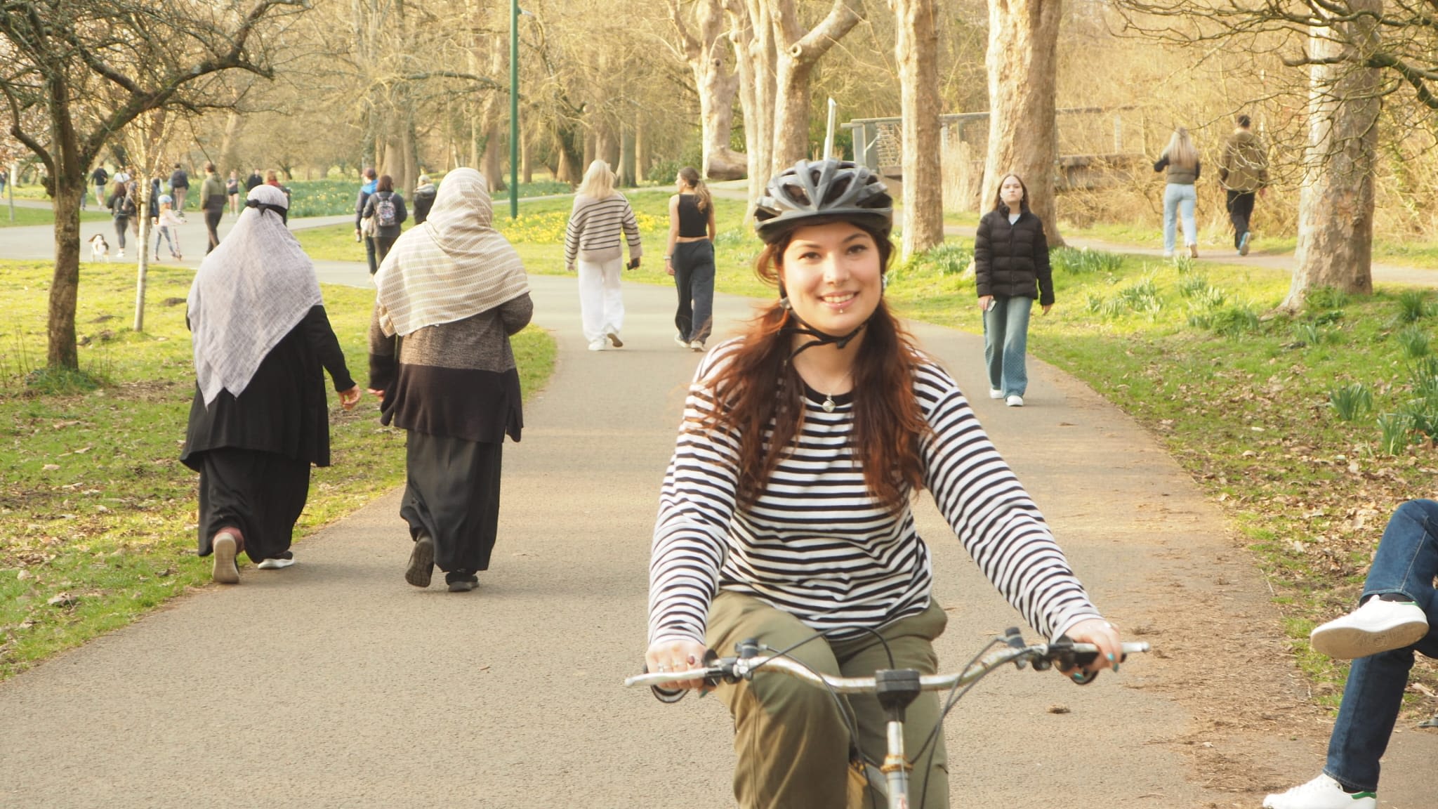 Beginner cyclist learning to ride in a park setting